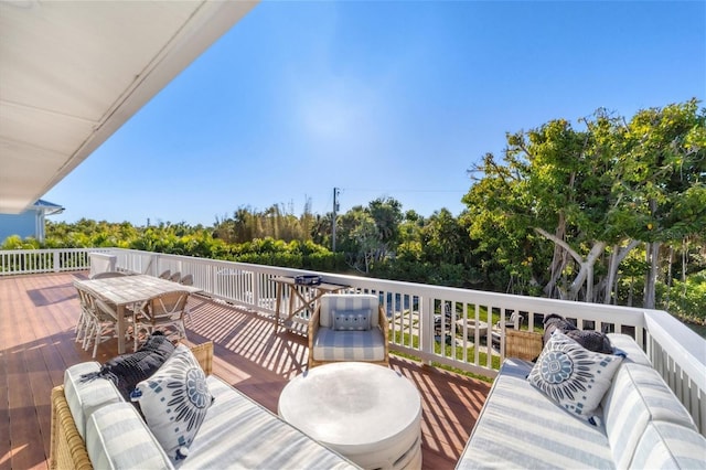 wooden deck with outdoor dining space and outdoor lounge area