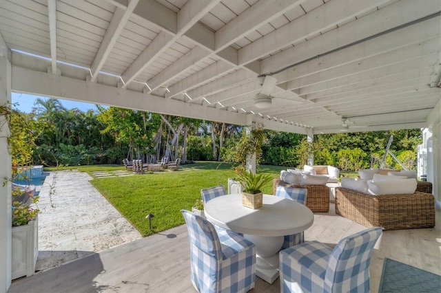 view of patio / terrace featuring outdoor dining area, an outdoor hangout area, and ceiling fan