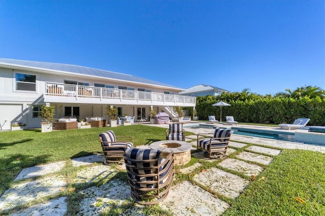 view of yard with an outdoor living space with a fire pit, a patio area, a fenced in pool, and a wooden deck