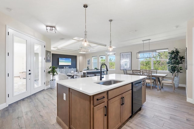 kitchen with dishwashing machine, brown cabinetry, light wood finished floors, a sink, and french doors