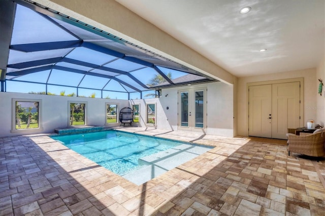 outdoor pool featuring a patio, french doors, and a lanai