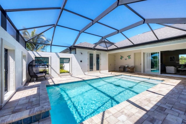 pool with a patio area, french doors, and a lanai