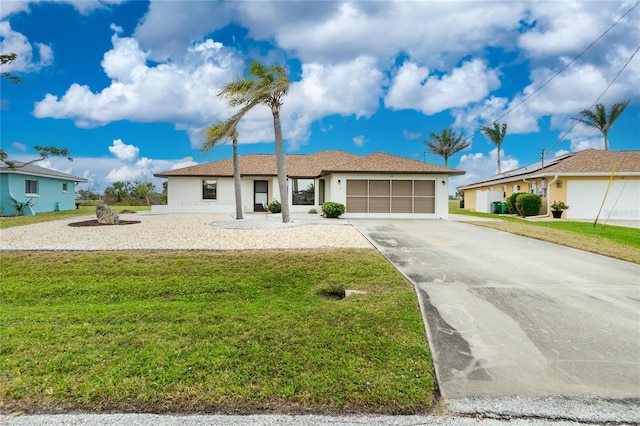 single story home with stucco siding, driveway, an attached garage, and a front yard