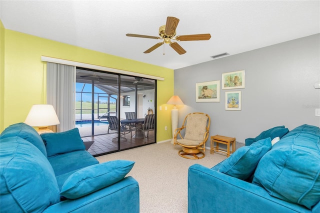 carpeted living area with visible vents, baseboards, and ceiling fan