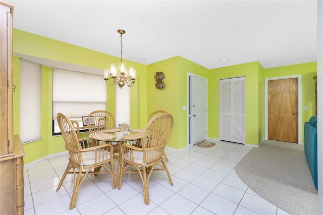 dining room with light tile patterned flooring, a notable chandelier, and baseboards