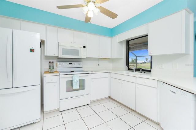 kitchen with a sink, white appliances, white cabinets, light countertops, and ceiling fan