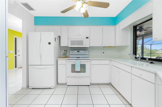 kitchen with a sink, visible vents, white appliances, and light tile patterned floors