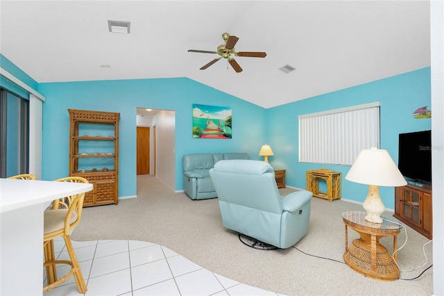 carpeted living room with visible vents, lofted ceiling, ceiling fan, and tile patterned flooring