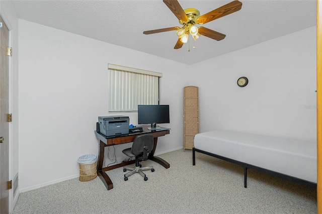 office space with carpet flooring, a ceiling fan, baseboards, and a textured ceiling