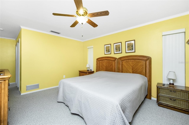 carpeted bedroom featuring visible vents, crown molding, and baseboards