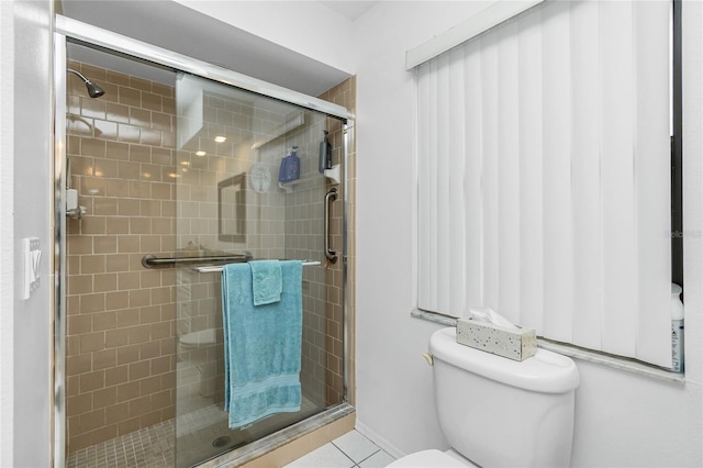 full bath featuring tile patterned flooring, a shower stall, and toilet