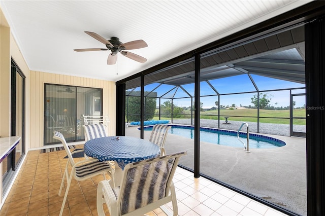 outdoor pool featuring a lanai, a ceiling fan, and a patio area