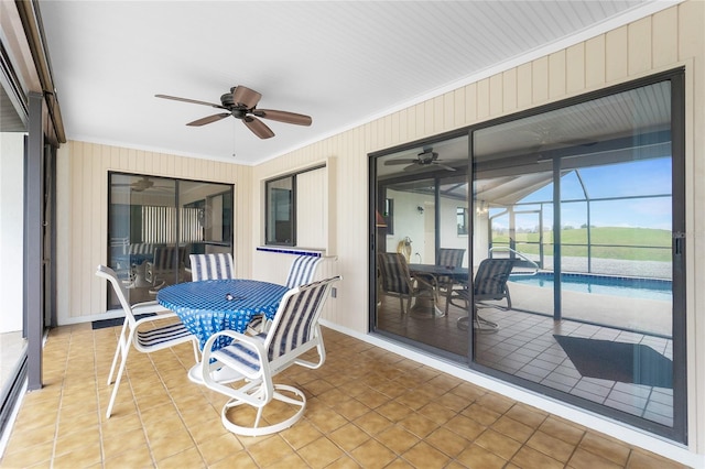 sunroom / solarium with a ceiling fan