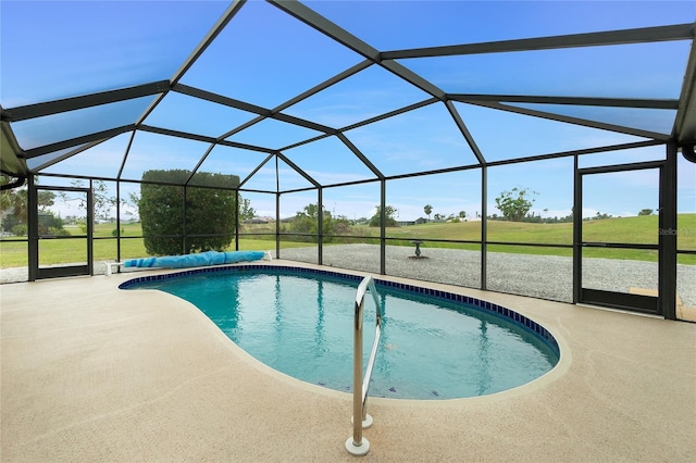 view of swimming pool featuring a patio area, a lanai, and a covered pool