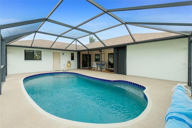 pool featuring a lanai, a ceiling fan, and a patio area