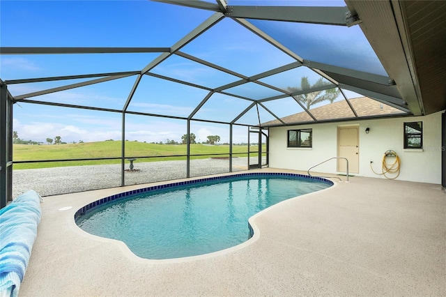 pool featuring glass enclosure, a yard, and a patio area