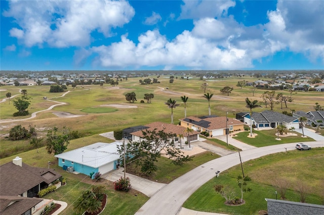 aerial view with golf course view and a residential view