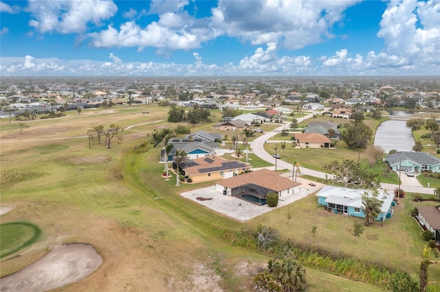 drone / aerial view with view of golf course and a residential view