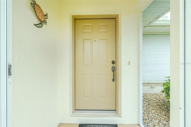 doorway to property with stucco siding