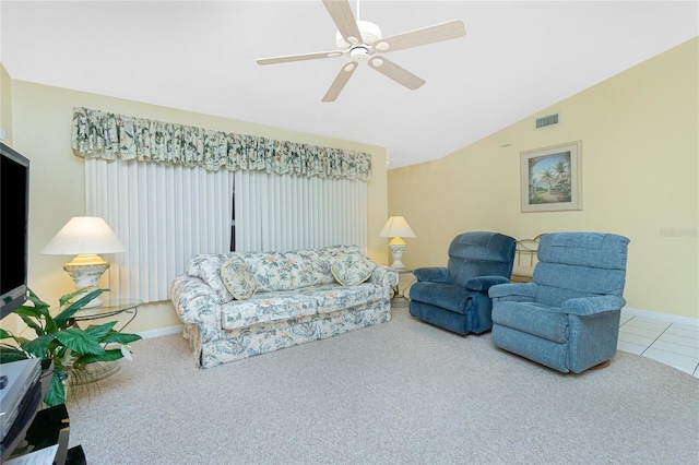 carpeted living area featuring baseboards, visible vents, lofted ceiling, ceiling fan, and tile patterned flooring