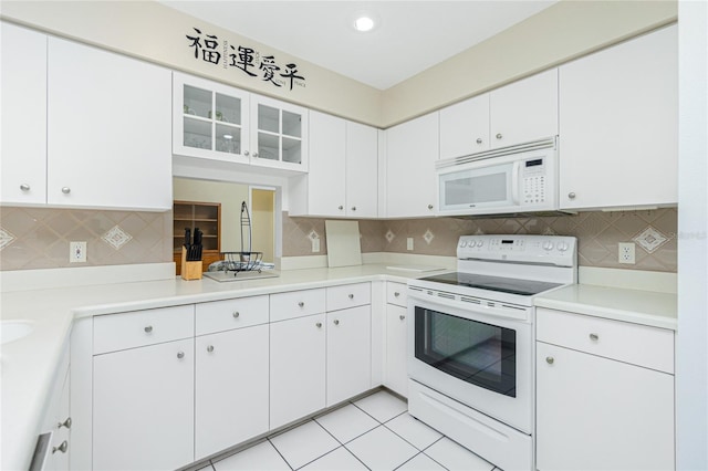 kitchen featuring light countertops, decorative backsplash, light tile patterned flooring, white appliances, and white cabinetry