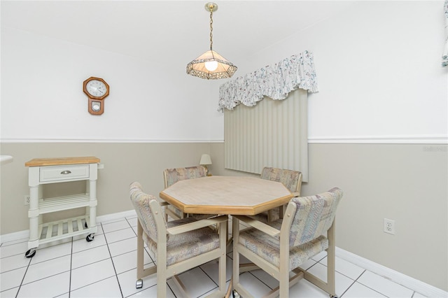 dining room featuring baseboards and light tile patterned flooring