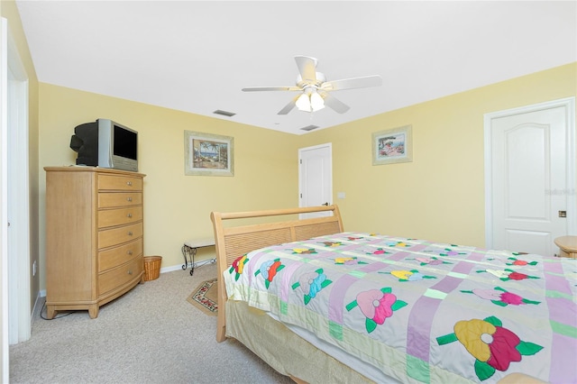 bedroom featuring baseboards, a ceiling fan, visible vents, and light carpet