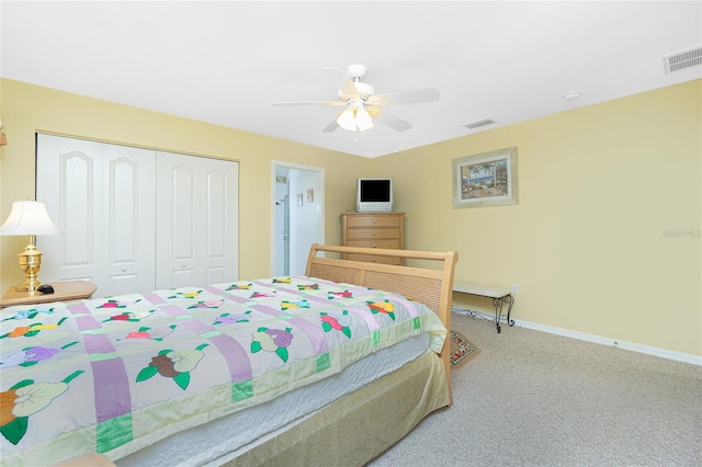 carpeted bedroom with a closet, visible vents, a ceiling fan, and baseboards