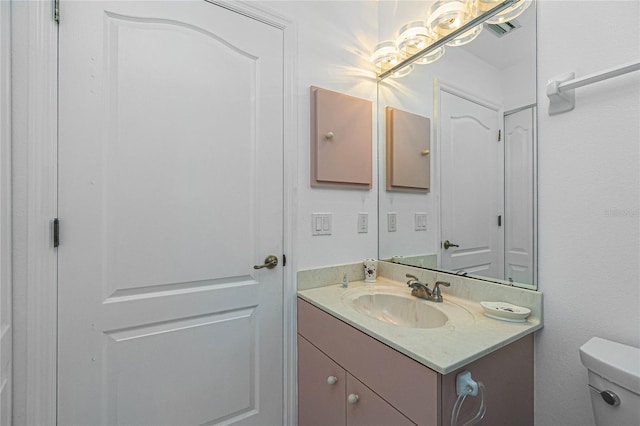 half bath featuring toilet and vanity