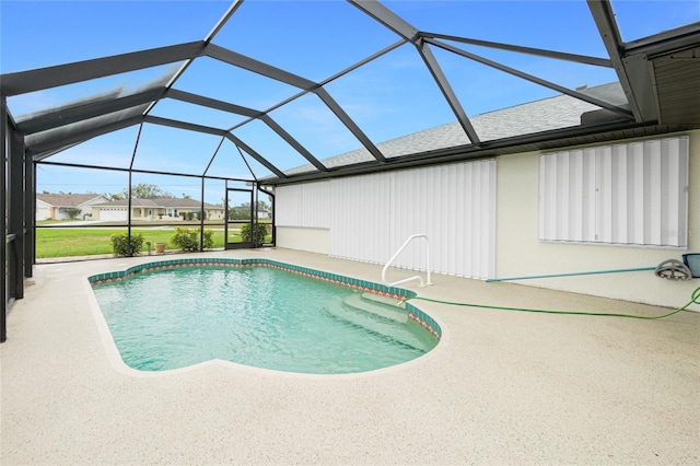 outdoor pool featuring glass enclosure and a patio