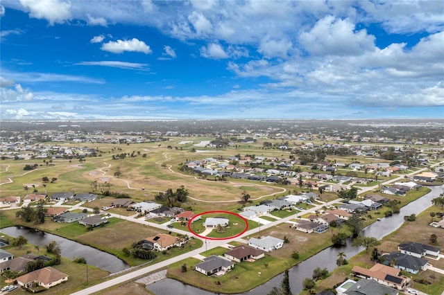 drone / aerial view with a residential view and a water view