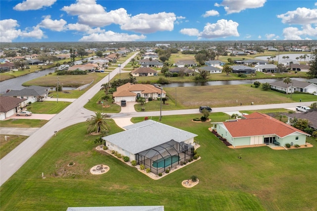 birds eye view of property featuring a residential view and a water view