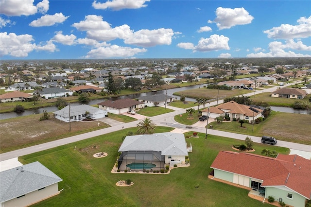 bird's eye view with a residential view and a water view