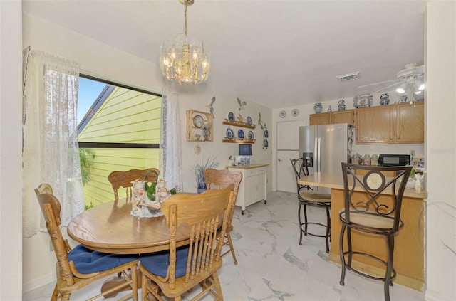 dining space featuring visible vents, marble finish floor, and ceiling fan