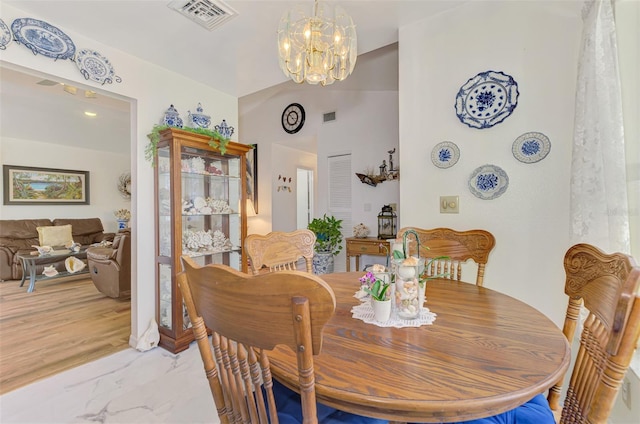 dining area with visible vents, marble finish floor, and a chandelier