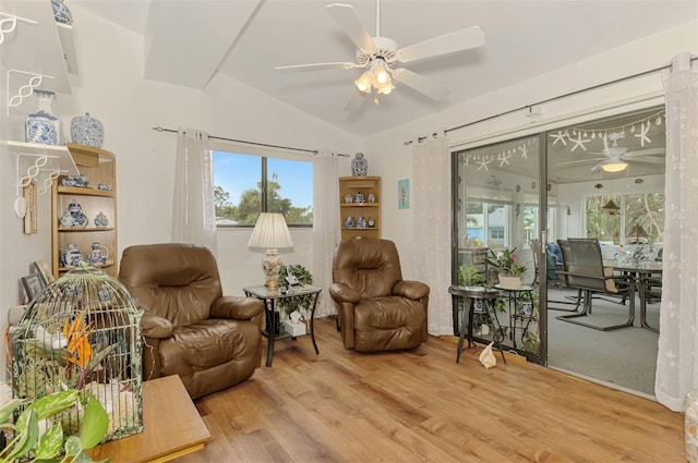 sitting room with a ceiling fan, lofted ceiling, and wood finished floors