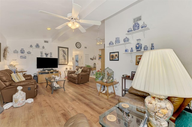 living area with visible vents, light wood-type flooring, lofted ceiling with beams, and ceiling fan