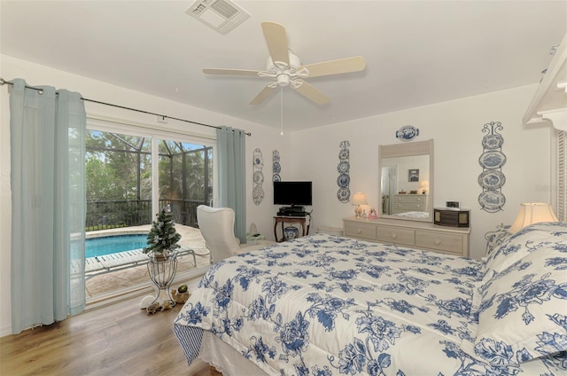 bedroom with visible vents, wood finished floors, ceiling fan, and access to outside