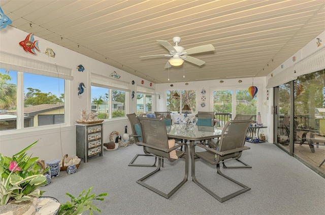 sunroom / solarium featuring plenty of natural light and a ceiling fan