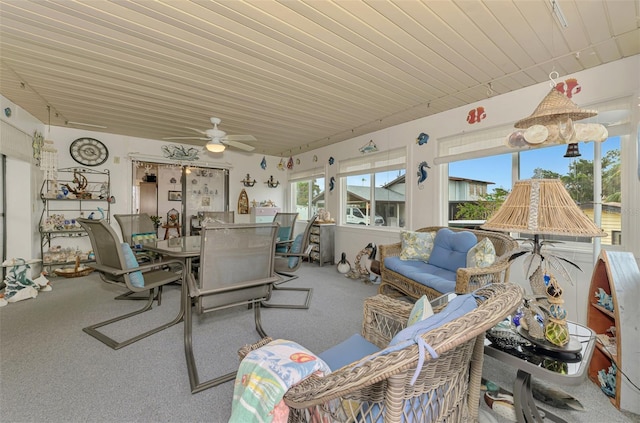 sunroom / solarium featuring a ceiling fan