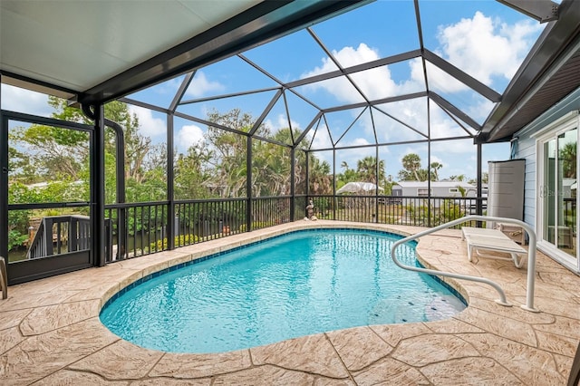 view of pool featuring a fenced in pool, glass enclosure, and a patio