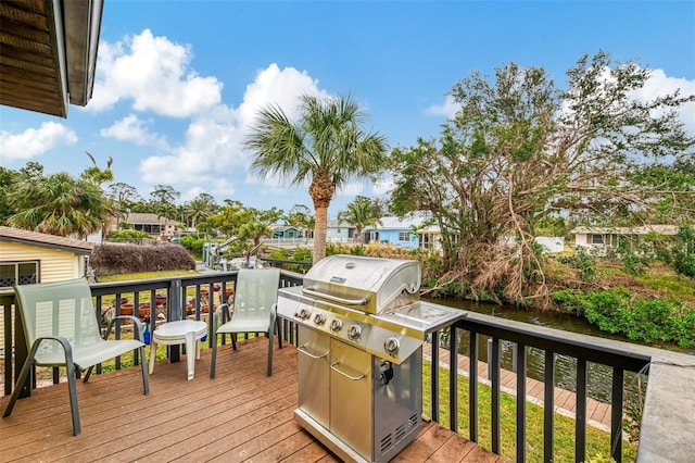 wooden deck featuring area for grilling and a residential view