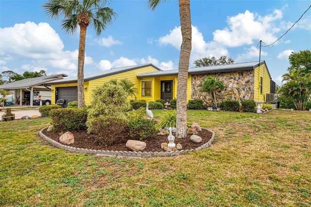 mid-century home with a front yard, metal roof, a garage, stone siding, and a standing seam roof