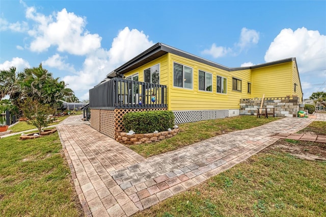 1173 Brown St, Englewood, FL 34224 - view of property exterior with a yard, a deck, and crawl space