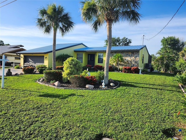 1173 Brown St, Englewood, FL 34224 - ranch-style house with a garage, a front yard, and a metal roof