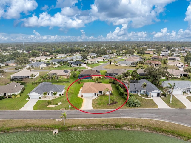 birds eye view of property featuring a residential view and a water view