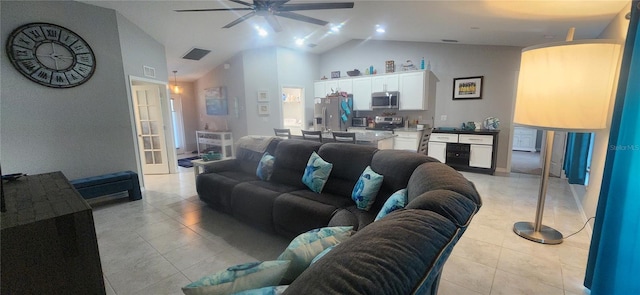 living area with light tile patterned flooring, visible vents, high vaulted ceiling, and a ceiling fan