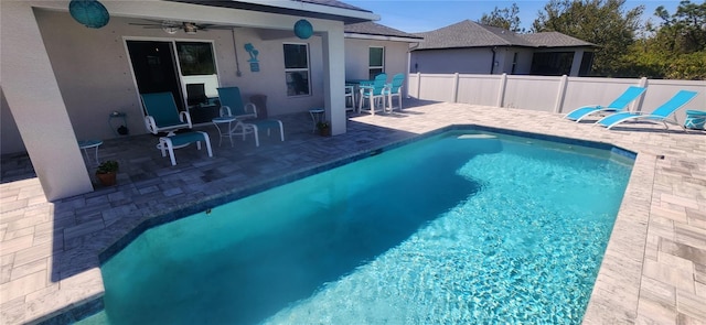 view of pool with a fenced in pool, a patio, ceiling fan, and fence