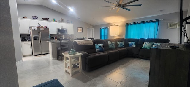 living area with light tile patterned floors, lofted ceiling, and a ceiling fan