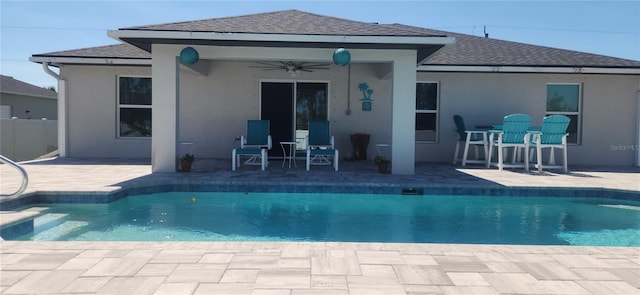 outdoor pool with a patio area, a ceiling fan, and fence